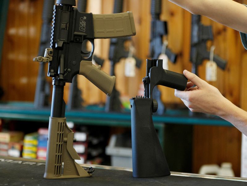 &copy; Reuters. FILE PHOTO: A bump fire stock, (R), that attaches to a semi-automatic rifle to increase the firing rate is seen at Good Guys Gun Shop in Orem, Utah, U.S., October 4, 2017. REUTERS/George Frey/File Photo