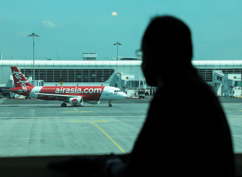 &copy; Reuters. FILE PHOTO: A traveller looks out at an aircraft as he waits for his flight at Kuala Lumpur International Airport 2 (KLIA2), as the country reopens its borders fully to allow entry without quarantine for visitors vaccinated against COVID-19 in Sepang, Sel