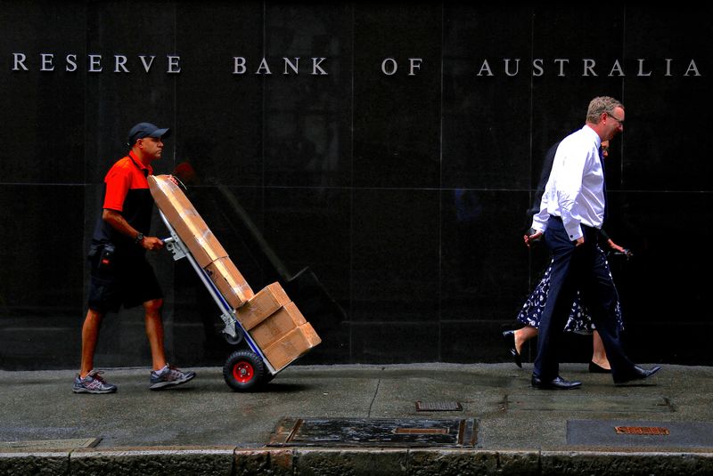 &copy; Reuters. FILE PHOTO: A worker pushing a trolley walks with pedestrians past the Reserve Bank of Australia (RBA) head office in central Sydney, Australia, March 7, 2017. REUTERS/David Gray
