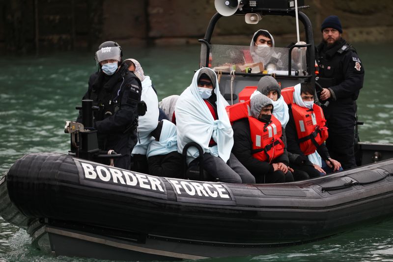 &copy; Reuters. FILE PHOTO: Migrants arrive into the Port of Dover onboard a Border Force vessel after being rescued while crossing the English Channel, in Dover, Britain, December 17, 2021. REUTERS/Henry Nicholls