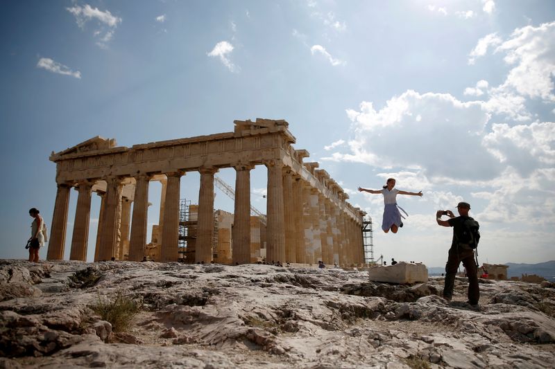 &copy; Reuters. FILE PHOTO: Tourists take a picture in front of the temple of the Parthenon atop the Acropolis in Athens, Greece July 20, 2018. REUTERS/Costas Baltas/File Photo