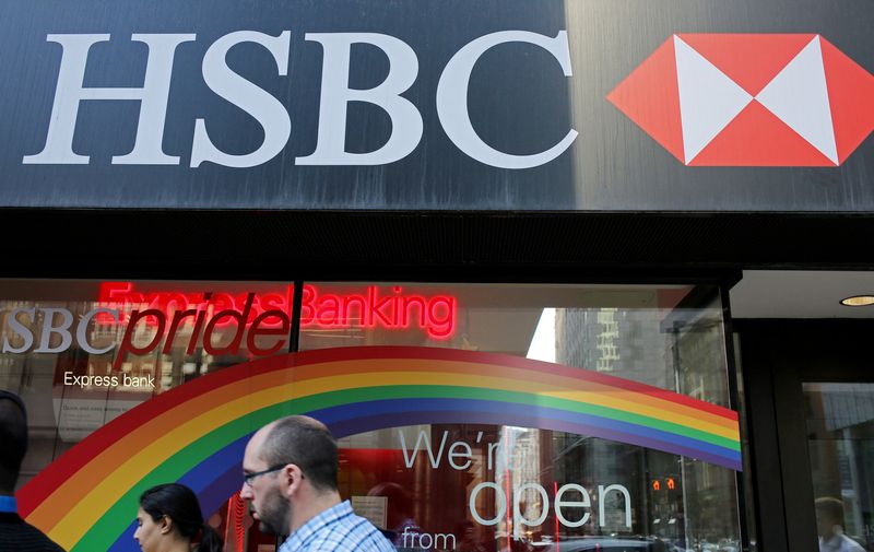 &copy; Reuters. FILE PHOTO: People pass by a branch of HSBC bank adorned with colours of the Pride rainbow flag symbolizing gay rights, in downtown Toronto, Ontario, Canada June 13, 2017. REUTERS/Chris Helgren