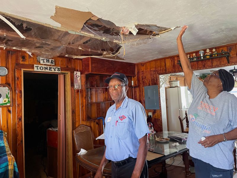 &copy; Reuters. Hubert and Betty Toney stand inside their home, which roof was torn off by Hurricane Ian, allowing water to pour into it, in Fort Myers, Florida, U.S., October 3, 2022. REUTERS/Rod Nickel