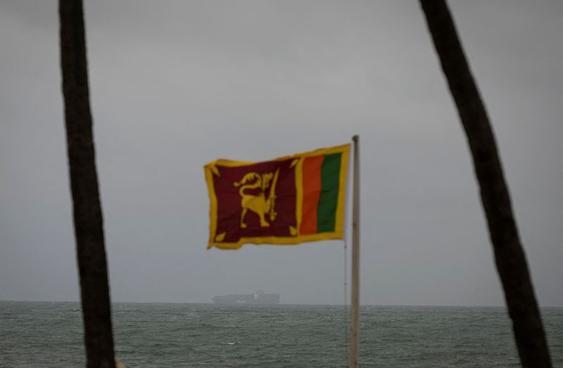 &copy; Reuters. FILE PHOTO: A cargo ship sails towards Colombo Harbour as a Sri Lankan national flag is seen, amid the country's economic crisis in Colombo, Sri Lanka, July 23, 2022. REUTERS/Adnan Abidi