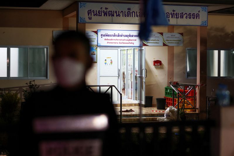 &copy; Reuters. A police officer stands outside a day care center which was the scene of a mass shooting, in the town of Uthai Sawan, around 500 km northeast of Bangkok in the province of Nong Bua Lam Phu, Thailand October 6, 2022. REUTERS/Athit Perawongmetha