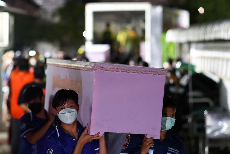 &copy; Reuters. Rescue workers carry a coffin containing the body of a victim at Udon Thani hospital in Udon Thani province, following a mass shooting in the town of Uthai Sawan, around 500 km northeast of Bangkok in the province of Nong Bua Lam Phu, Thailand October 7, 
