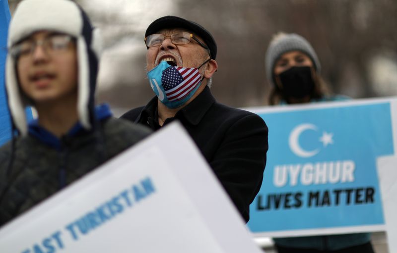 © Reuters. FILE PHOTO: Jamal Rehi chants with others during a rally to encourage Canada and other countries as they consider labeling China's treatment of its Uighur population and Muslim minorities as genocide, outside the Canadian Embassy in Washington, D.C., U.S. February 19, 2021. REUTERS/Leah Millis/File Photo