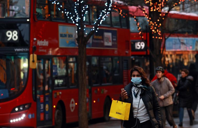 &copy; Reuters. FILE PHOTO: A shopper walks on Oxford Street in London, Britain December 18, 2020. REUTERS/Hannah Mckay