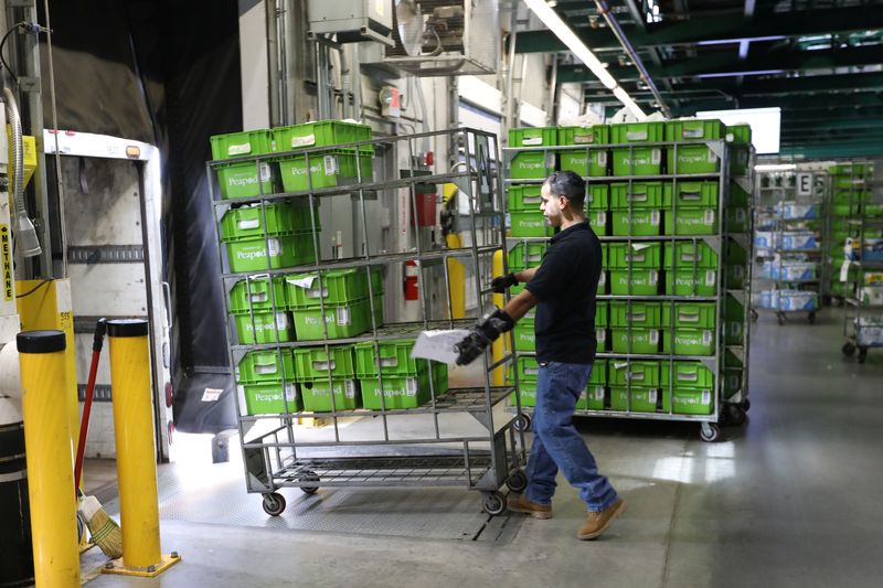 &copy; Reuters. A delivery worker loads trucks with totes packed with groceries for delivery inside a Peapod grocery distribution warehouse facility in Jersey City, New Jersey, U.S. August 21, 2018. Picture taken August 21, 2018. REUTERS/Mike Segar