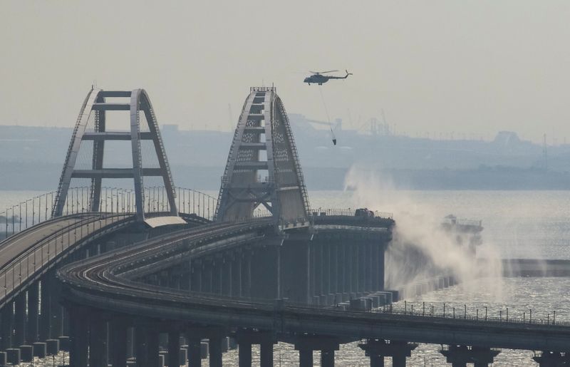 &copy; Reuters. A helicopter drops water to extinguish fuel tanks ablaze on the Kerch bridge in the Kerch Strait, Crimea, October 8, 2022.  REUTERS/Stringer