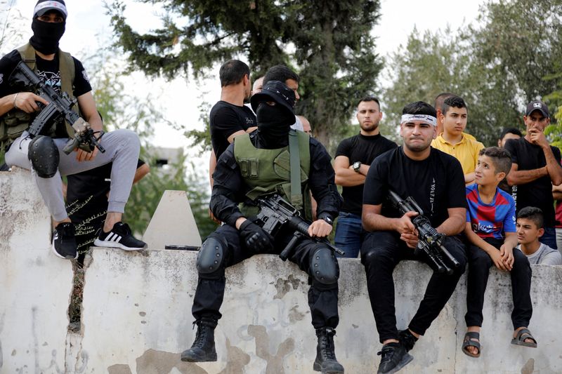 © Reuters. Armed men attend the funeral of Palestinian Mahmoud Al-Sous, who was killed by Israeli forces during clashes in raid, in Jenin in the Israeli-occupied West Bank October 8, 2022. REUTERS/Raneen Sawafta     