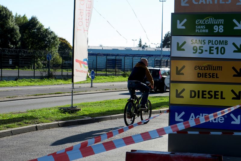 © Reuters. A cyclist rides past a closed TotalEnergies gas station near a petrol storage facility in Haulchin, near Valenciennes, France, October 9, 2022. REUTERS/Pascal Rossignol