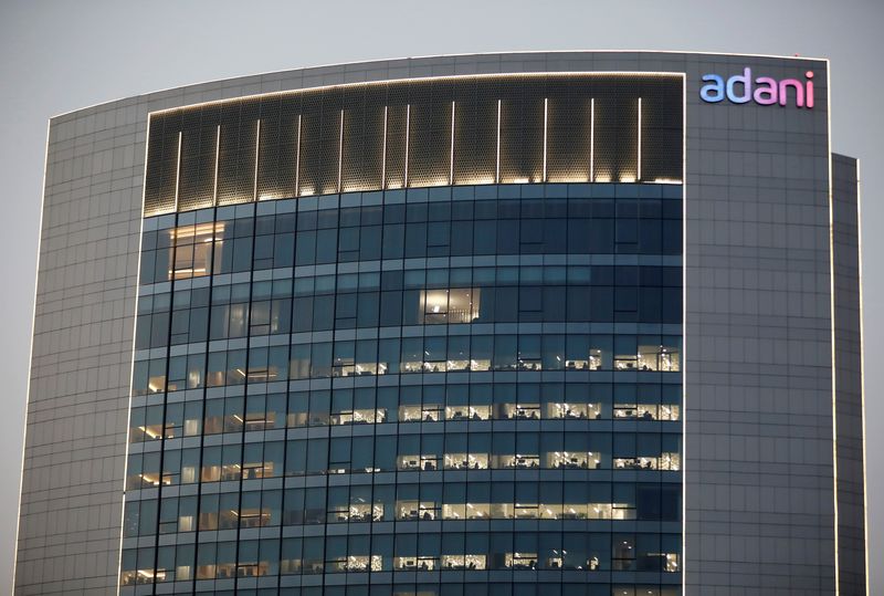 &copy; Reuters. FILE PHOTO: The logo of the Adani Group is seen on the facade of one of its buildings on the outskirts of Ahmedabad, India, April 13, 2021. REUTERS/Amit Dave