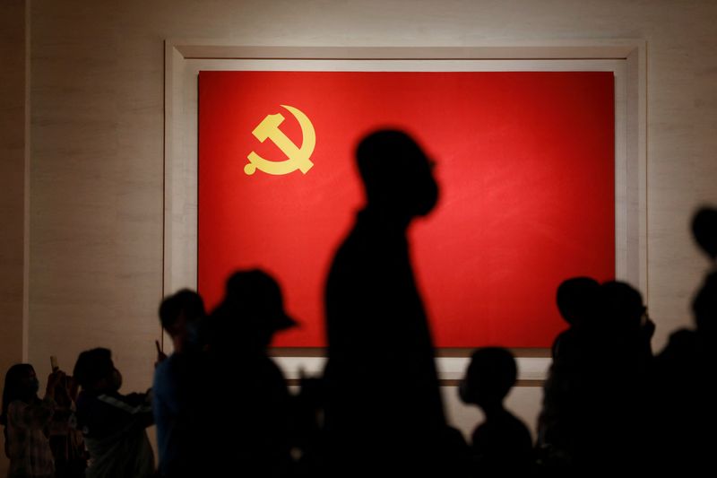 &copy; Reuters. FILE PHOTO: Visitors are seen silhouetted against a Chinese Communist Party flag displayed at the Museum of the Communist Party of China in Beijing, China September 3, 2022. REUTERS/Florence Lo