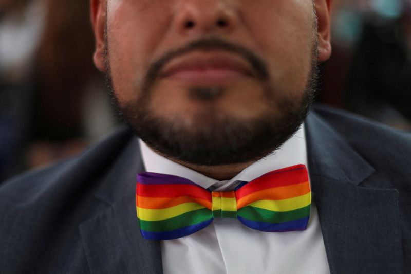 &copy; Reuters. FILE PHOTO: A man shows his bowtie as he celebrates LGBTQ+ pride month with a massive wedding of same sex couples in Mexico City, Mexico, June 24, 2022. REUTERS/Edgard Garrido/File Photo