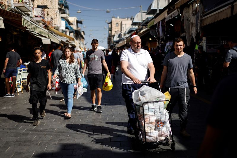 &copy; Reuters. FILE PHOTO: Shoppers carry their groceries through Mahane Yehuda market in Jerusalem, September 30, 2022. REUTERS/Amir Cohen