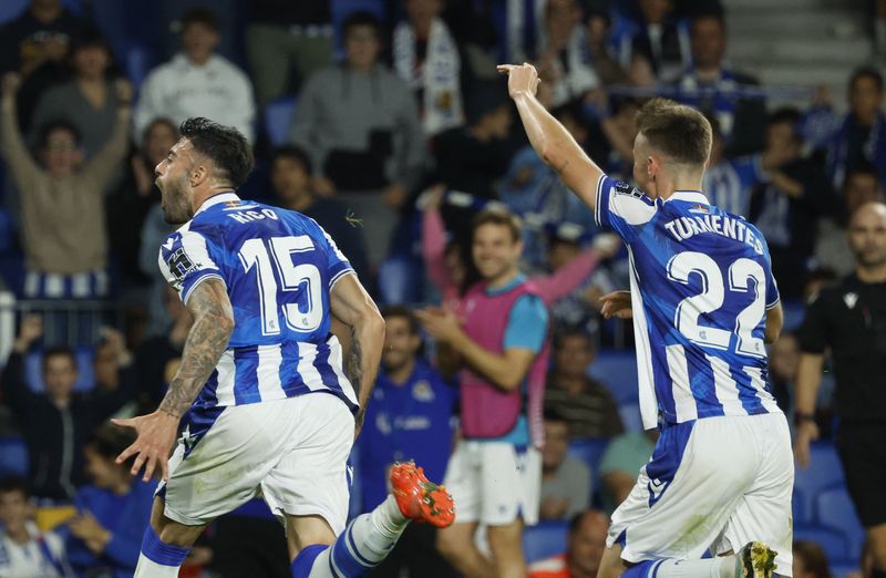 © Reuters. Soccer Football - Europa League - Group E - Real Sociedad v FC Sheriff Tiraspol - Reale Arena, San Sebastian, Spain - October 13, 2022 Real Sociedad's Diego Rico celebrates scoring their second goal with Benat Turrientes REUTERS/Vincent West