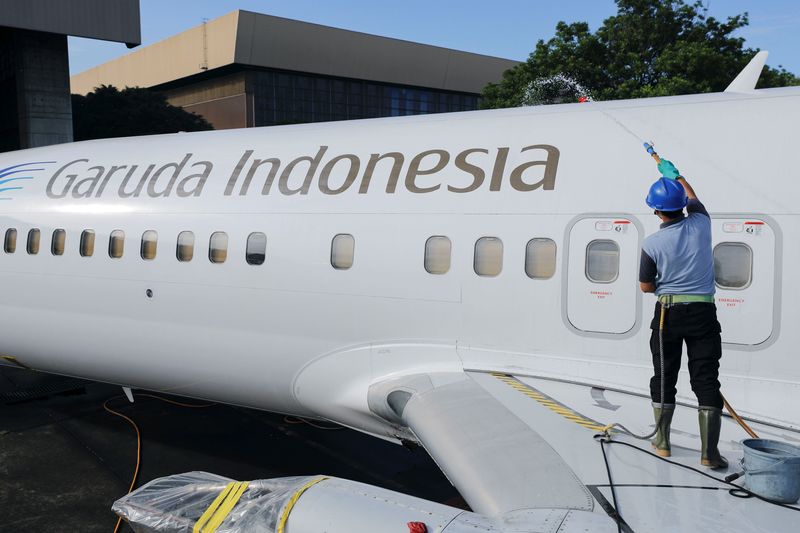 &copy; Reuters. FILE PHOTO: A worker cleans a Garuda Indonesia's aircraft parked at the Garuda Maintenance Facility (GMF) AeroAsia, at Soekarno-Hatta International airport near Jakarta, Indonesia, January 21, 2022. REUTERS/Willy Kurniawan