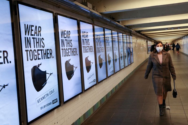 &copy; Reuters. FILE PHOTO: A subway rider passes ads for face masks at Times Square station in Manhattan, as the global outbreak of the coronavirus disease (COVID-19) continues, in New York City, U.S., November 14, 2020. REUTERS/Caitlin Ochs/