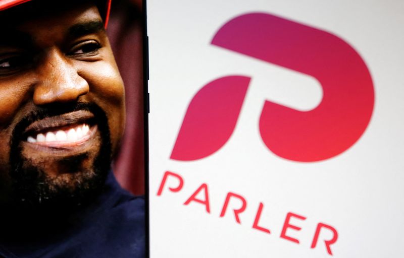 © Reuters. American rapper Kanye West's picture is seen on a smartphone next to the logo of social media app Parler in this Illustration taken, October 17, 2022. REUTERS/Dado Ruvic/Illustration