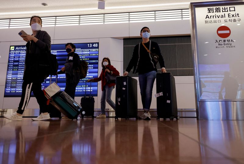 &copy; Reuters. FILE PHOTO: Passengers walk upon their arrival at the Haneda International Airport, on the first day Japan opened its doors to tourists after closing them for two-and-a-half years due to travel restrictions sparked by the outbreak of the coronavirus disea