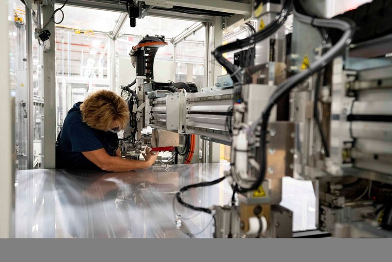 &copy; Reuters. FILE PHOTO: Connie Black makes adjustments to the manufacturing line for the series 6 solar panels seen during a tour of a First Solar plant in Walbridge, Ohio, U.S., October 6, 2021.   REUTERS/Dane Rhys