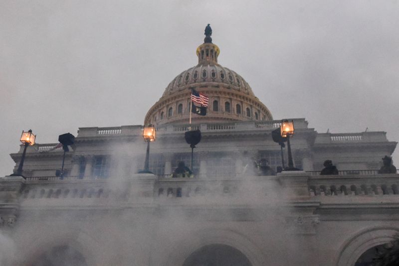 &copy; Reuters. FILE PHOTO: Police clear the U.S. Capitol Building with tear gas as supporters of U.S. President Donald Trump gather outside, in Washington, U.S. January 6, 2021. REUTERS/Stephanie Keith/File Photo