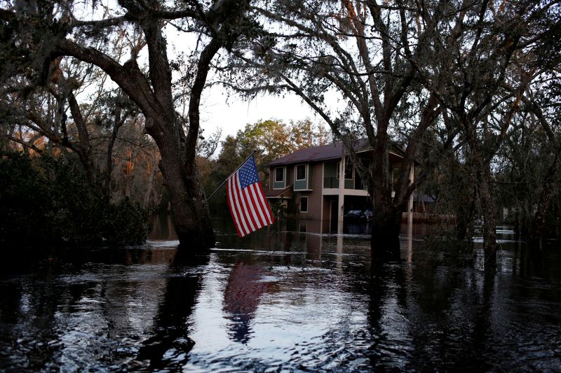 &copy; Reuters. FILE PHOTO: A U.S. flag is seen in a flooded rural area after Hurricane Ian caused widespread destruction in Arcadia, Florida, U.S., October 4, 2022. REUTERS/Marco Bello