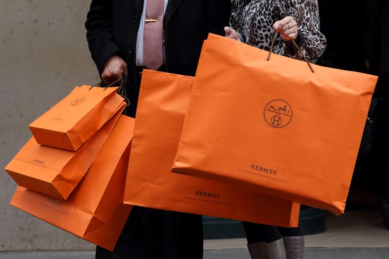 &copy; Reuters. A couple walk with Hermes shopping bags as they leave an Hermes store in Paris March 21, 2013. REUTERS/Philippe Wojazer/Files