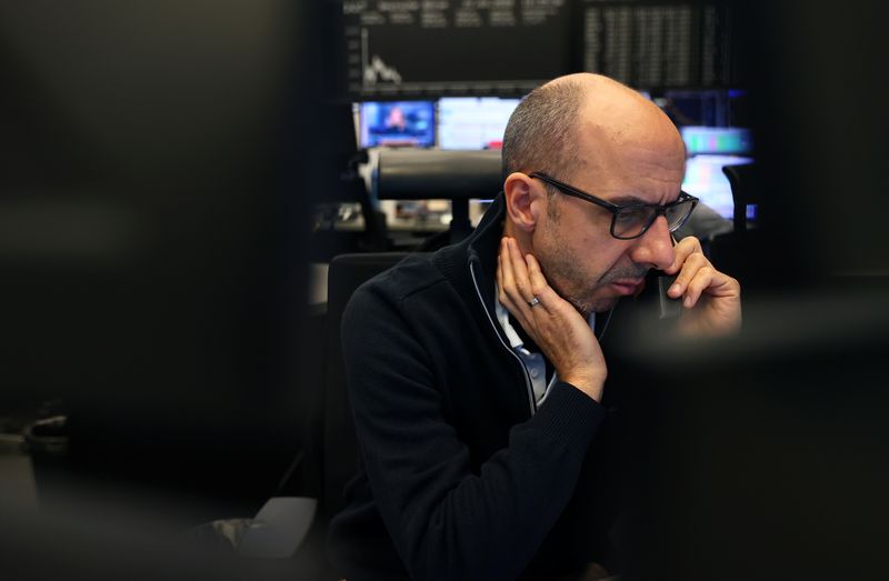 &copy; Reuters. FILE PHOTO: A stock broker works at Frankfurt's stock exchange as markets react on the coronavirus disease (COVID-19), at the stock exchange in Frankfurt, Germany, March 27, 2020. REUTERS/Kai Pfaffenbach