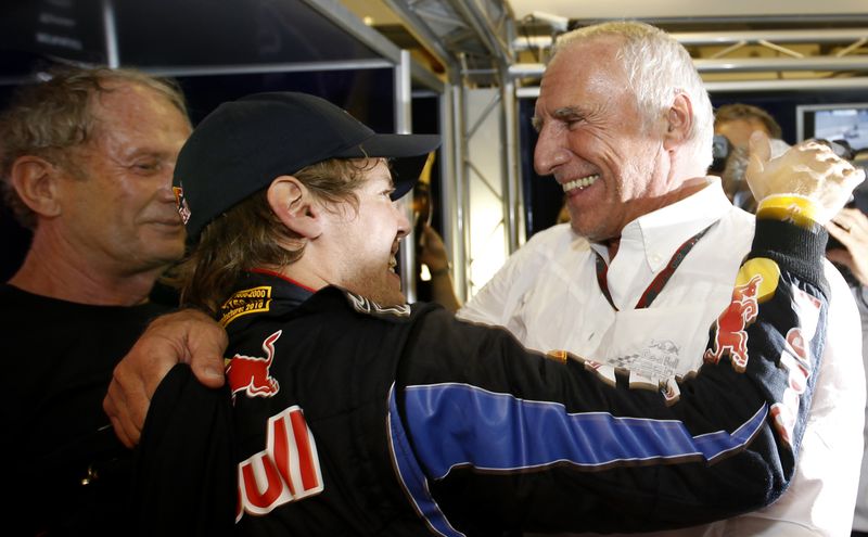 © Reuters. FILE PHOTO: Red Bull owner Dietrich Mateschitz (R) congratulates Red Bull Formula One driver Sebastian Vettel of Germany for winning the championship and the Abu Dhabi Grand Prix at the Yas Marina circuit November 14, 2010. REUTERS/Ahmed Jadallah