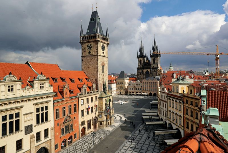 &copy; Reuters. FILE PHOTO: A clock showing the time at noon is pictured on a building, next to almost empty streets at Old Town Square during the coronavirus disease (COVID-19) outbreak, in Prague, Czech Republic, March 31, 2020. REUTERS/David W Cerny/File Photo