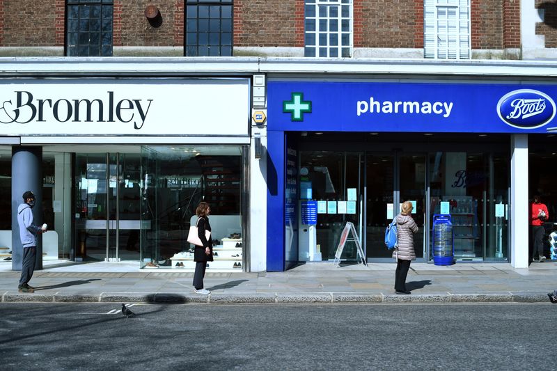 &copy; Reuters. FILE PHOTO: People stand apart as they follow social distancing while they queue outside a Boots pharmacy shop, as the spread of coronavirus disease (COVID-19) continues in London, Britain March 24, 2020. REUTERS/Dylan Martinez