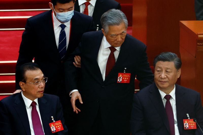 &copy; Reuters. Former Chinese president Hu Jintao leaves his seat next to Chinese President Xi Jinping and Premier Li Keqiang, during the closing ceremony of the 20th National Congress of the Communist Party of China, at the Great Hall of the People in Beijing, China Oc