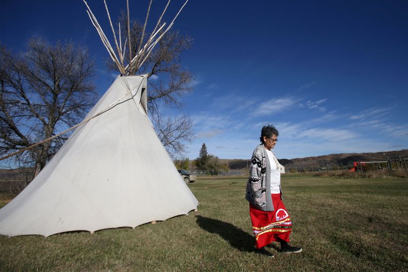 &copy; Reuters. FILE PHOTO: Eunice Delorme, a mother to five, grandmother to eight and great-grandmother to five, who also helped raise 17 foster children, a professional Kokum, or grandmother, that works with families at Scared Wolf Lodge poses on Cowessess First Nation
