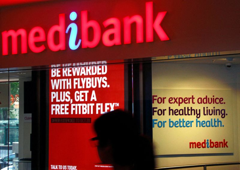 &copy; Reuters. FILE PHOTO: A woman walks past a branch of the Australian health insurer Medibank Private in Sydney October 20, 2014.   REUTERS/David Gray