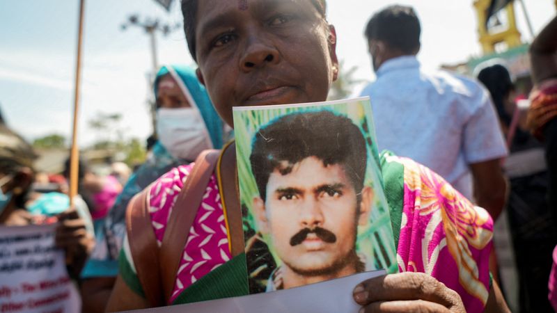 &copy; Reuters. A woman holds up a photo of her missing relative during a protest in Kilinochchi, Northern Province, Sri Lanka, August 12, 2022. REUTERS/Joseph Campbell