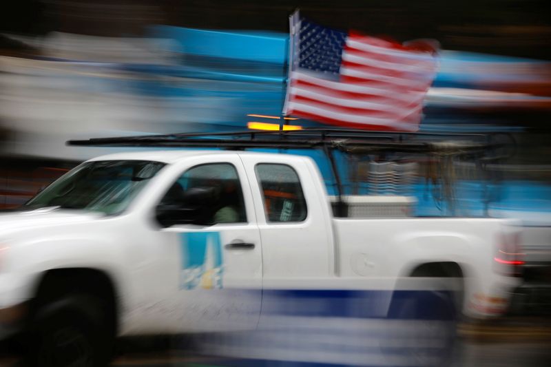&copy; Reuters. FILE PHOTO: A PG&E truck carrying an American Flag drives past PG&E repair trucks in Paradise, California, U.S. November 21, 2018.  REUTERS/Elijah Nouvelage
