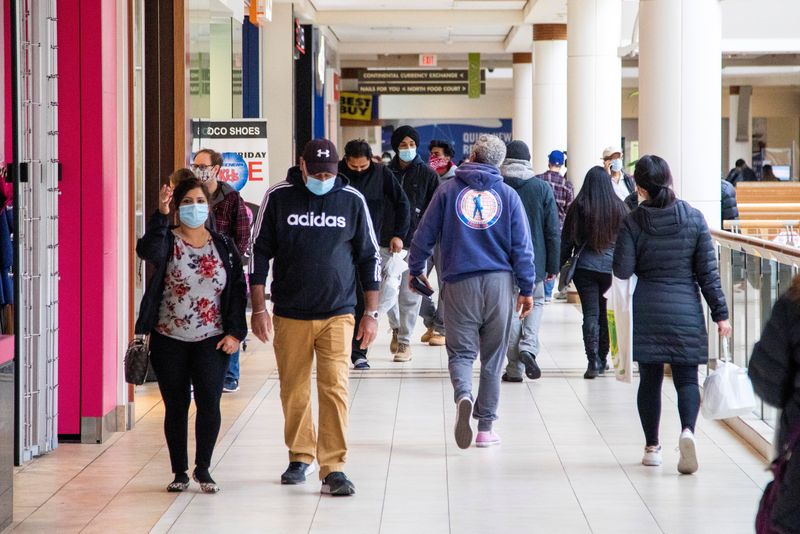 &copy; Reuters. FILE PHOTO - Shoppers walk in Bramalea City Centre mall in Brampton two days before COVID-19 restrictions are reintroduced to Greater Toronto Area regions in Ontario, Canada November 21, 2020.  REUTERS/Carlos Osorio