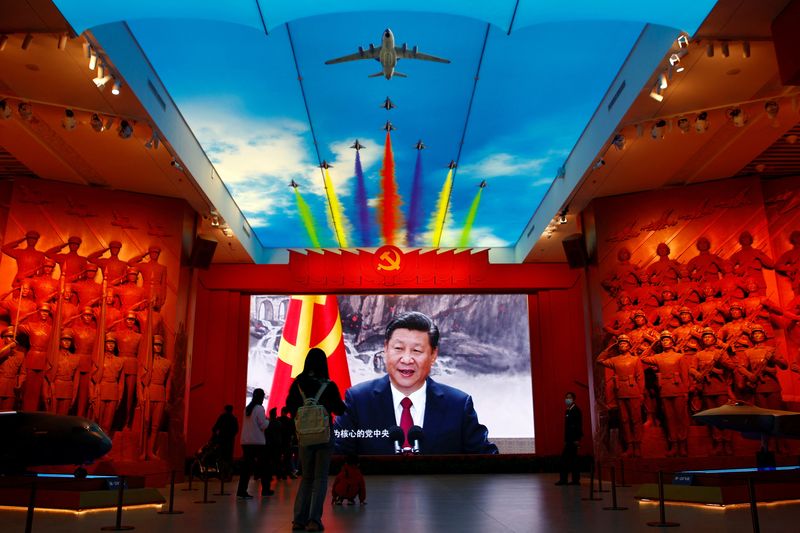 &copy; Reuters. FILE PHOTO: Visitors stand in front of a giant screen displaying Chinese President Xi Jinping next to a flag of the Communist Party of China, at the Military Museum of the Chinese People's Revolution in Beijing, China October 8, 2022. REUTERS/Florence Lo/
