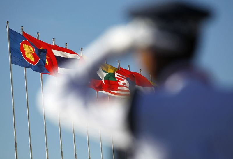 &copy; Reuters. FILE PHOTO: A police officer stands near national flags of ASEAN counties flags during the 25th ASEAN Summit in Myanmar International Convention Centre in Naypyitaw November 12, 2014. REUTERS/Soe Zeya Tun/File Photo