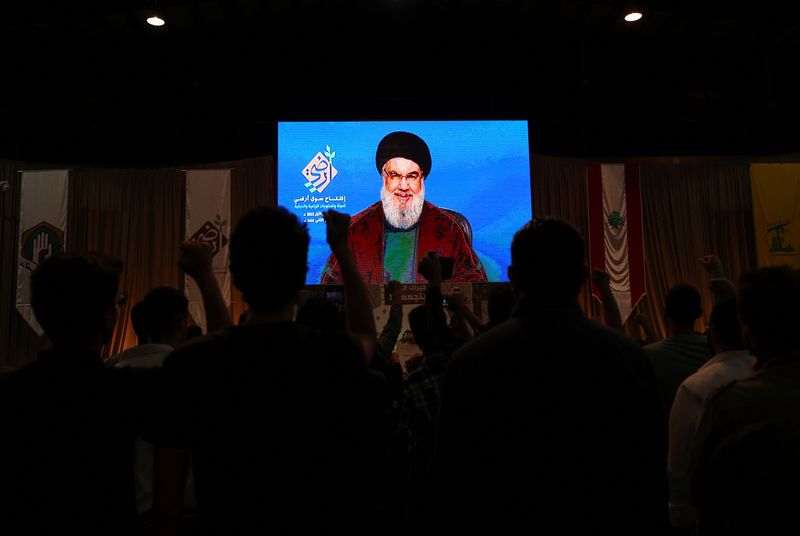 &copy; Reuters. أفراد يشاهدون كلمة لزعيم حزب الله حسن نصر الله عبر شاشة تلفزيونية بالضاحية الجنوبية في بيروت يوم الخميس. تصوير: محمد عزاقير - رويترز. 