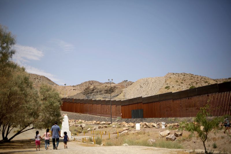 &copy; Reuters. FILE PHOTO: People walk near a border wall section allegedly built with money from Trump supporters who donated in the crowdfunding campaign called "We Build the Wall" as seen along the U.S.-Mexico border in Ciudad Juarez, Mexico, August 20, 2020. REUTERS