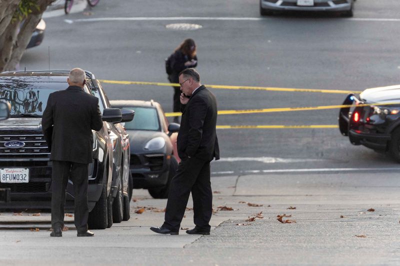 &copy; Reuters. People stand near police tape outside the home of U.S. House Speaker Nancy Pelosi where her husband Paul Pelosi was violently assaulted after a break-in at their house, according to a statement from her office, in San Francisco, California, U.S., October 