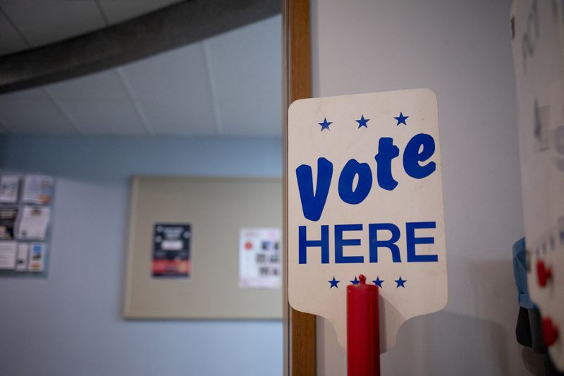 &copy; Reuters. FILE PHOTO - A 'Vote Here' sign is seen at a precinct the day before Michigan Democrats and Republicans choose their nominees to contest November's congressional elections, which will determine which party controls U.S. House of Representatives for next t