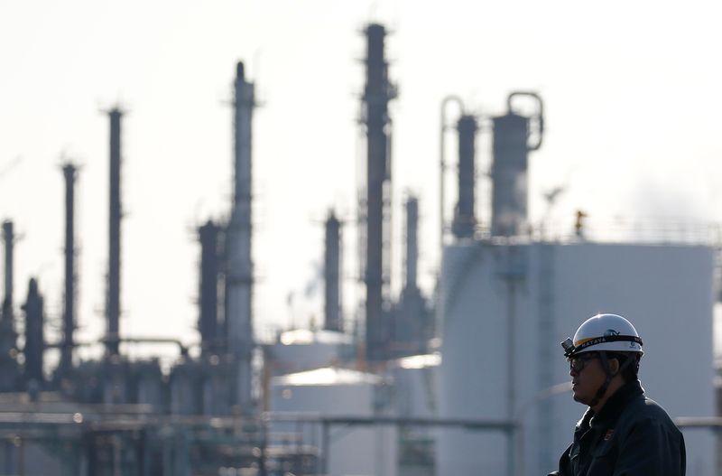 &copy; Reuters. FILE PHOTO: A worker walks near a factory at the Keihin industrial zone in Kawasaki, Japan February 28, 2017. REUTERS/Issei Kato