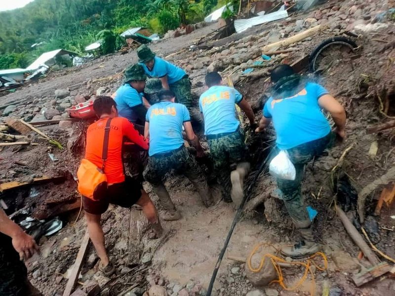 &copy; Reuters. Philippine Coast Guard (PCG) and Philippine National Police (PNP) rescuers retrieve a body following flooding and landslides due to Tropical Storm Nalgae, in Datu Odin Sinsuat, Maguindanao, October 28, 2022. Philippine Coast Guard/Handout via REUTERS 