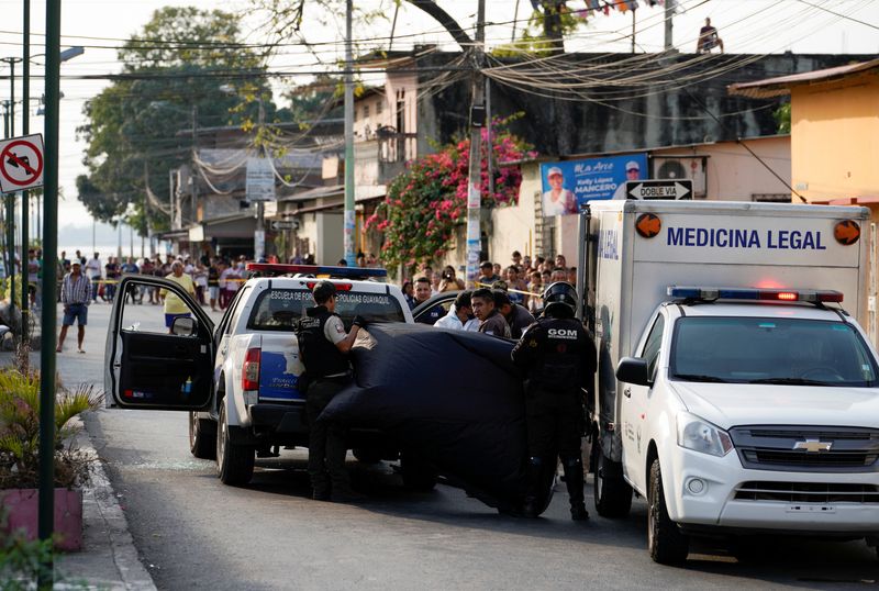 © Reuters. Police officers cover a crime scene where colleagues were killed in response to prisoner transfers from overcrowded prisons, prompting President Guillermo Lasso to declare a state of emergency in two provinces, in Guayaquil, Ecuador November 1, 2022. REUTERS/Santiago Arcos