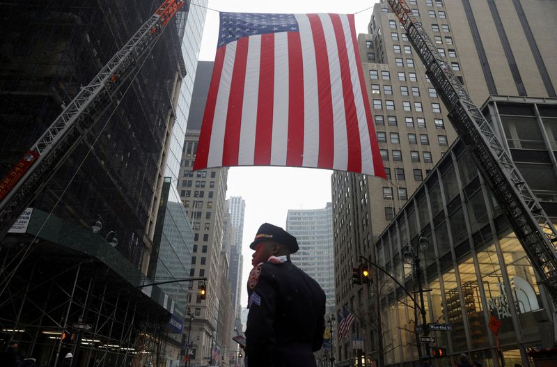 &copy; Reuters. FILE PHOTO: A police officer stands under U.S. flag during funeral service for New York City Police Department (NYPD) officer Jason Rivera, who was killed in the line of duty while responding to a domestic violence call, at St. Patrick's Cathedral in the 