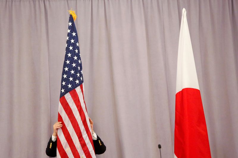 &copy; Reuters. FILE PHOTO: A worker adjusts the U.S. flag before Japanese Prime Minister Shinzo Abe addresses media following a meeting with President-elect Donald Trump in Manhattan, New York, U.S., November 17, 2016.  REUTERS/Andrew Kelly
